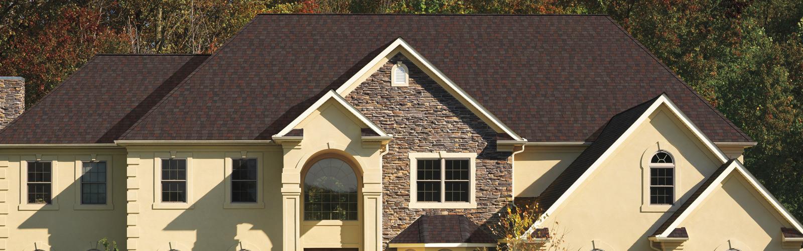 Mid-class home with a red-ish dark brown shingle roof